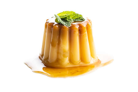 Sweet vanilla pudding. Sweet dessert with caramel topping isolated on white background.