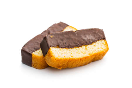 Sliced sponge dessert. Sweet sponge cake with chocolate isolated on white table.