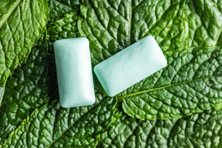 Mint chewing gum pads on green mint leaves. Top view.の写真素材