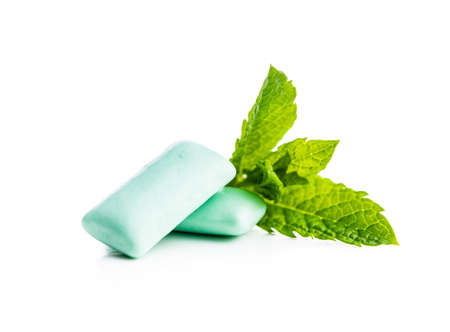 Mint chewing gum pads and green mint leaves isolated on white background.の写真素材