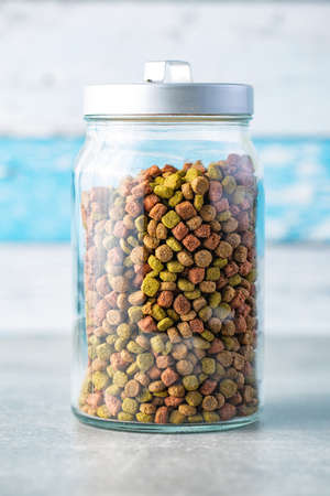 Dry kibble animal food. Dried food for cats or dogs in jar.の写真素材