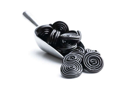 Spiral from liquorice candy in scoop isolated on white background.の写真素材