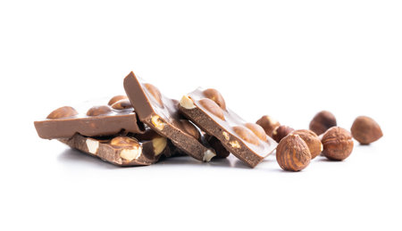 Nutty chocolate with hazelnuts isolated on white background.