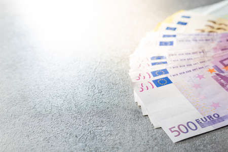 Euro banknotes on a rusty background.