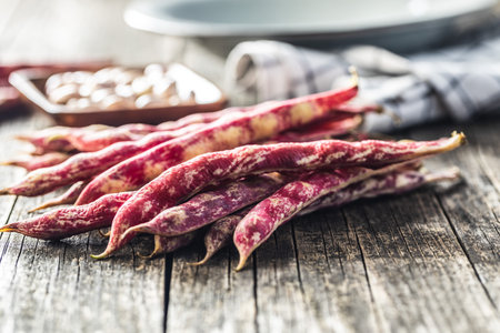 Cranberry beans. Borlotti beans. Beans pods on wooden table.の写真素材