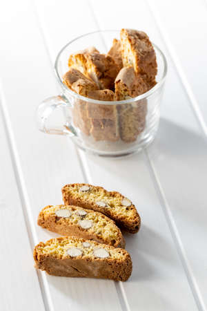 Italian cantuccini cookies. Sweet dried biscuits with almonds on white table.