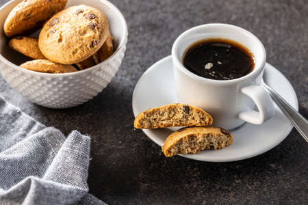 Coffee cup and sweet cookies on black table.の写真素材