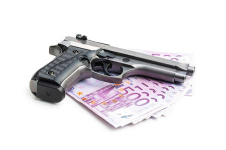 Hand gun and euro banknotes isolated on white background.の写真素材