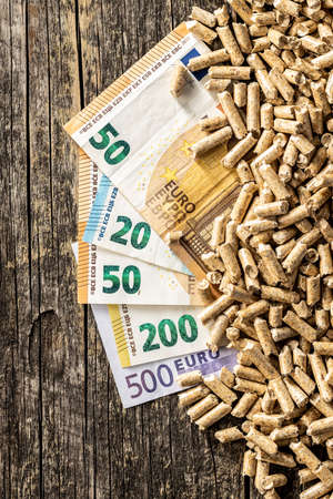 Wooden pellets and euro banknotes. Ecological heating. Top view.の写真素材