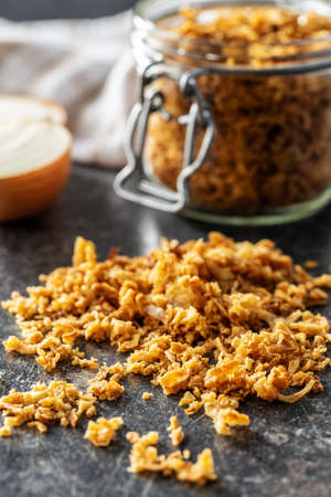 Pieces of fried onions on black table.の写真素材