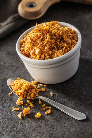 Pieces of fried onions in bowl.の写真素材