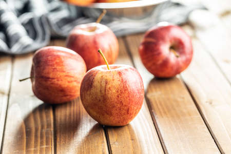 Fresh autumn apples on wooden table.
