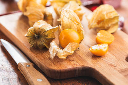 Physalis peruviana on cutting board. Cape Gooseberry or ground cherries fruit on wooden table.の写真素材