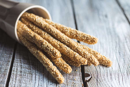 Breadsticks grissini. Bread sticks with sesame seeds in cup.の写真素材
