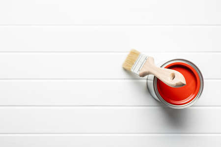 Clean paint brush and can of color on white table.の写真素材