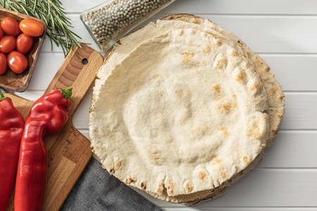 Arabic bread. Flat pita bread on white table. Top view.
