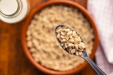 Breakfast cereals. Oat pops on a spoon. Top view.