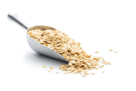 Breakfast cereals. Uncooked oatmeal. Raw oat flakes isolated on white background.の写真素材