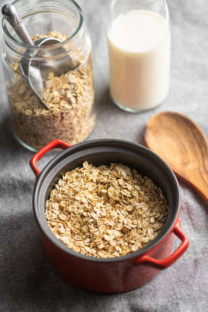 Breakfast cereals. Uncooked oatmeal. Raw oat flakes in pot.の写真素材