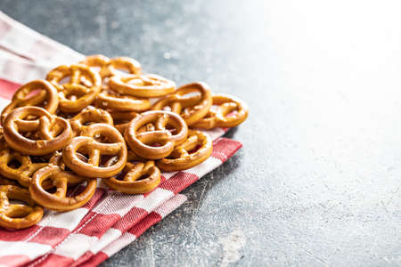 Mini pretzels. Crusty salted snack on a kitchen table.