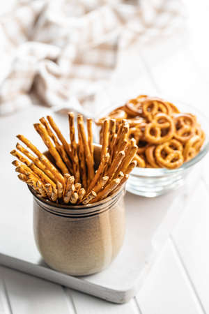 Mini pretzels and salted sticks. Crusty salted snack on a cutting board.の写真素材