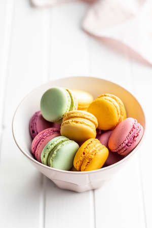 Sweet colorful macarons. Traditional french macaroons. Tasty dessert in bowl.の写真素材