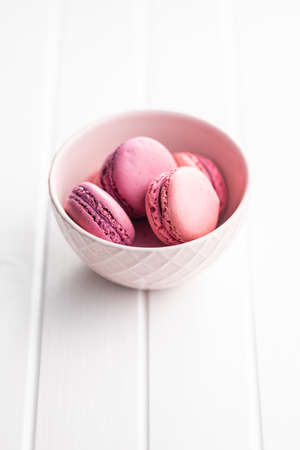 Sweet pink macarons. Traditional french macaroons. Tasty dessert in a bowl.の写真素材