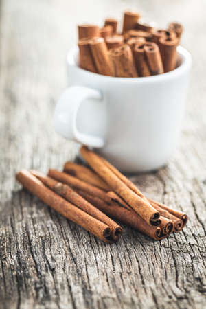 Dry cinnamon sticks on a wooden table. Cinnamon spice.の写真素材