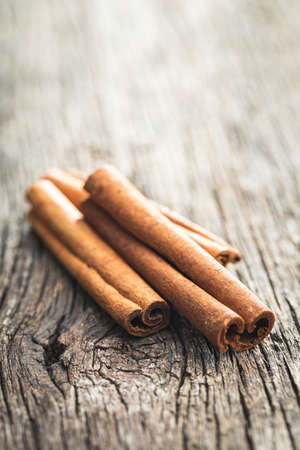 Dry cinnamon sticks on a wooden table. Cinnamon spice.の写真素材
