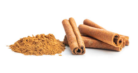 Dry cinnamon sticks and cinnamon powder isolated on a white background. Cinnamon spice.