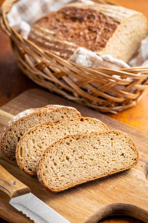 Sliced loaf of bread on a cutting board.