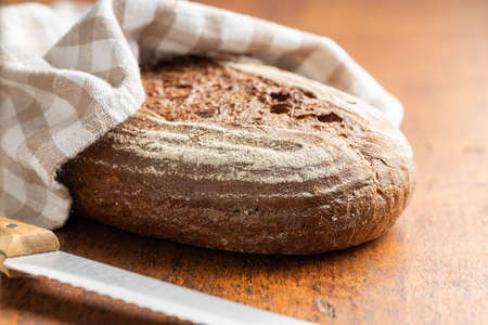 Loaf of bread on a wooden table.