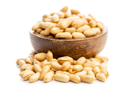 Roasted peeled peanuts in a bowl isolated on a white background.の写真素材