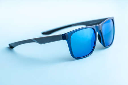 The fashion sunglasses on a blue background.の写真素材