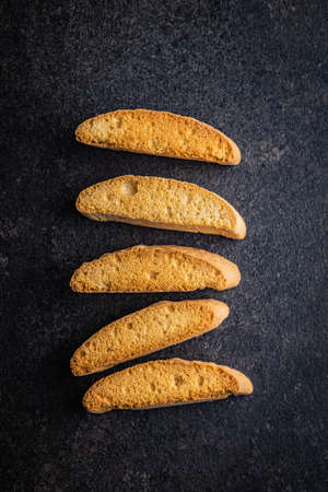 Sweet anicini cookies. Italian biscotti with anise flavor on a black table. Top view.の写真素材