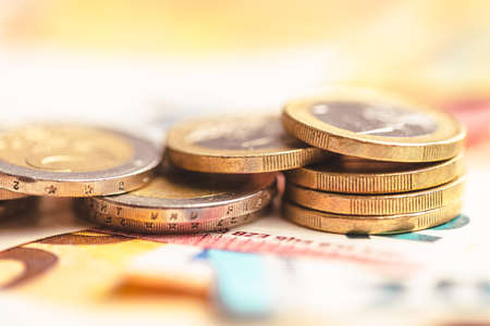 Euro coins on a paper euro banknotes