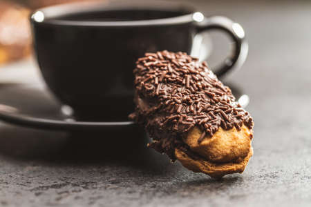 Petit fours with chocolate sprinkles. Mini chocolate dessert and a coffee cup.の写真素材