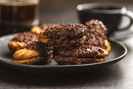 Petit fours with chocolate sprinkles. Mini chocolate dessert on a plate.の写真素材