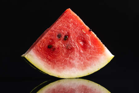 Slices of red watermelon on a black background.
