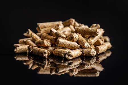 Wooden pellets on a black background. Biomass - Renewable source of heating.の写真素材