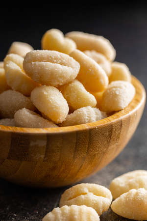 Uncooked potato gnocchi in a bowl. Tasty italian food.の写真素材