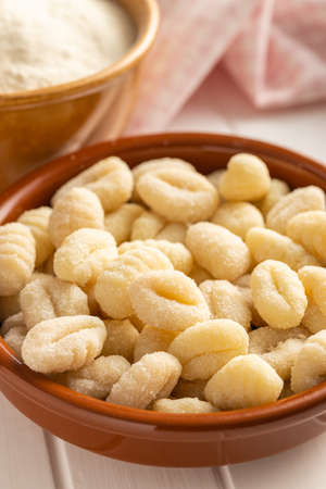 Uncooked potato gnocchi in a bowl. Tasty italian food.
