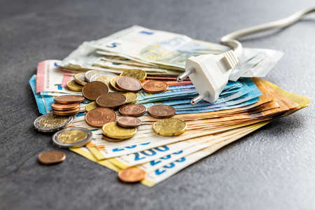 Electric plug and euro money. Concept of the increasing electricity prices.