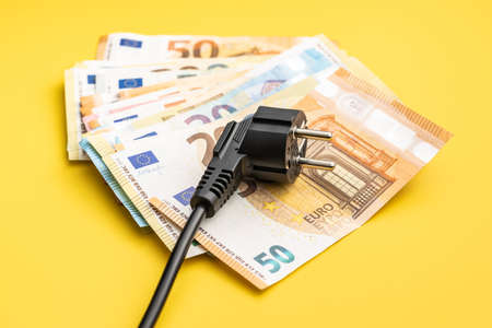 Electric plug and euro money. Concept of the increasing electricity prices.の写真素材