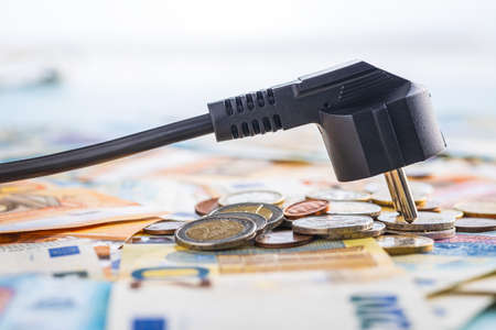 Electric plug and euro money. Concept of the increasing electricity prices.の写真素材