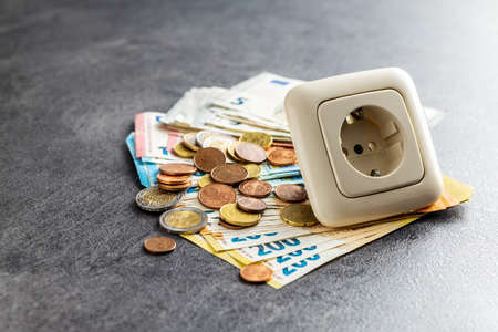 Electric socket and euro money. Concept of the increasing electricity prices.