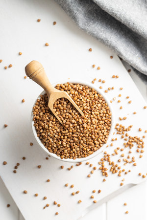 Uncooked buckwheat grain in the bowl. Top view.の写真素材