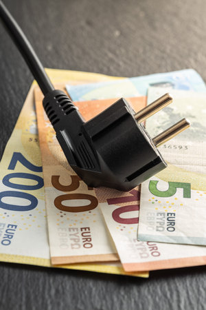 Electric plug and the euro money. Concept of increasing electric prices.の写真素材