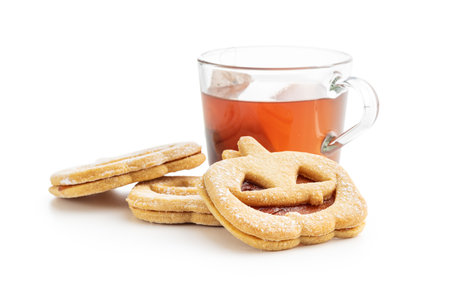 Linzer cookies in the shape of a Halloween pumpkin isolated on the white background.の写真素材