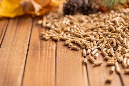 Wooden pellets on the wooden table.